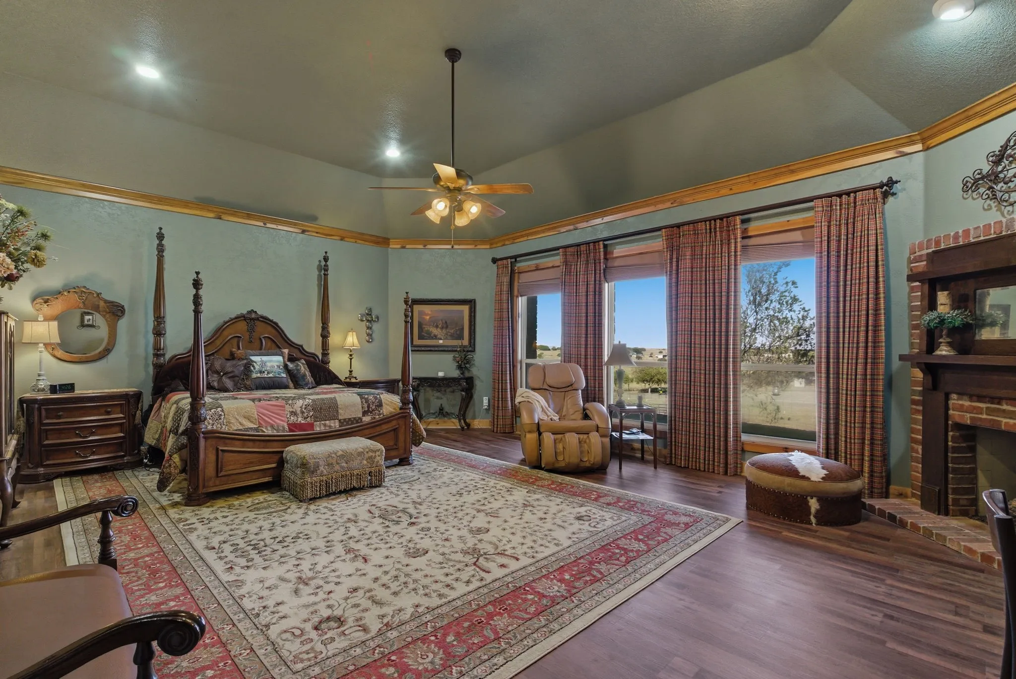 Primary bedroom with sitting area and gas fireplace