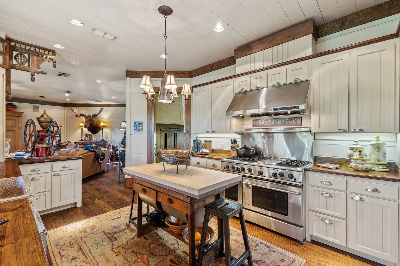 Commercial-grade kitchen with generous island and warm wood tones