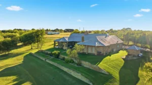 Stone home perched on the rise of 10 rolling acres at 135 Serrano in Weatherford, Texas