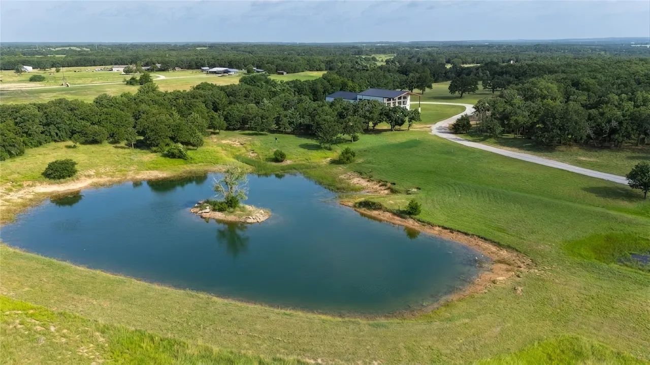 Aerial view of the property showing the stocked pond and pasture