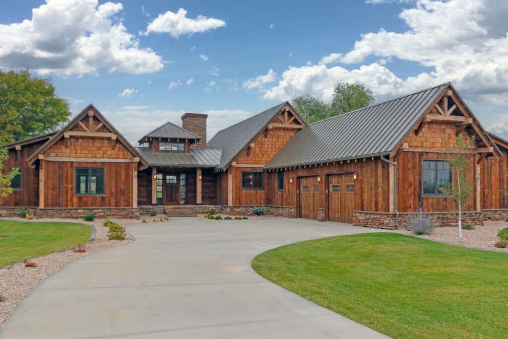 Rustic mountain ranch house plan exterior with wood siding, gable roof and covered porch, 3 bedrooms, 2,886 sq ft
