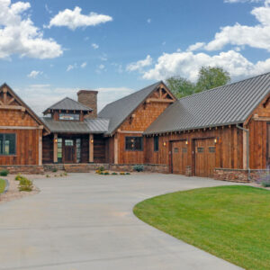 Rustic mountain ranch house plan exterior with wood siding, gable roof and covered porch, 3 bedrooms, 2,886 sq ft