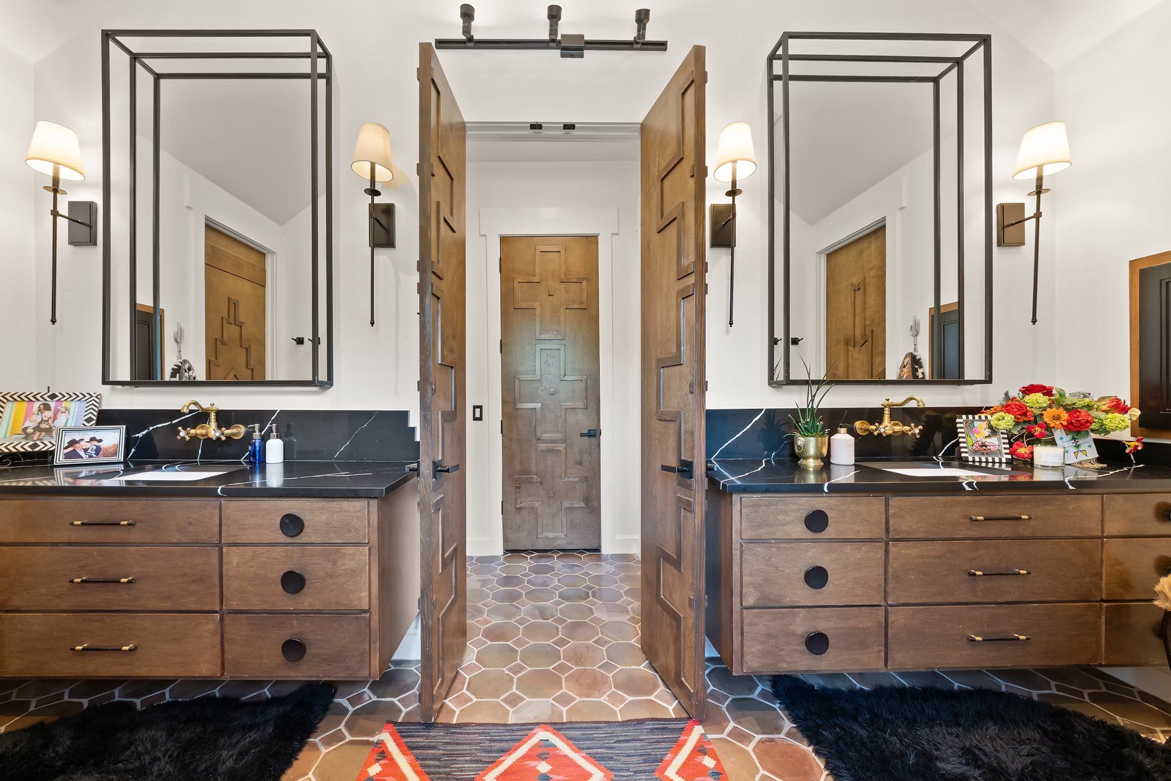 Shower and tub alcove wrapped in graphic black and white Southwestern tile