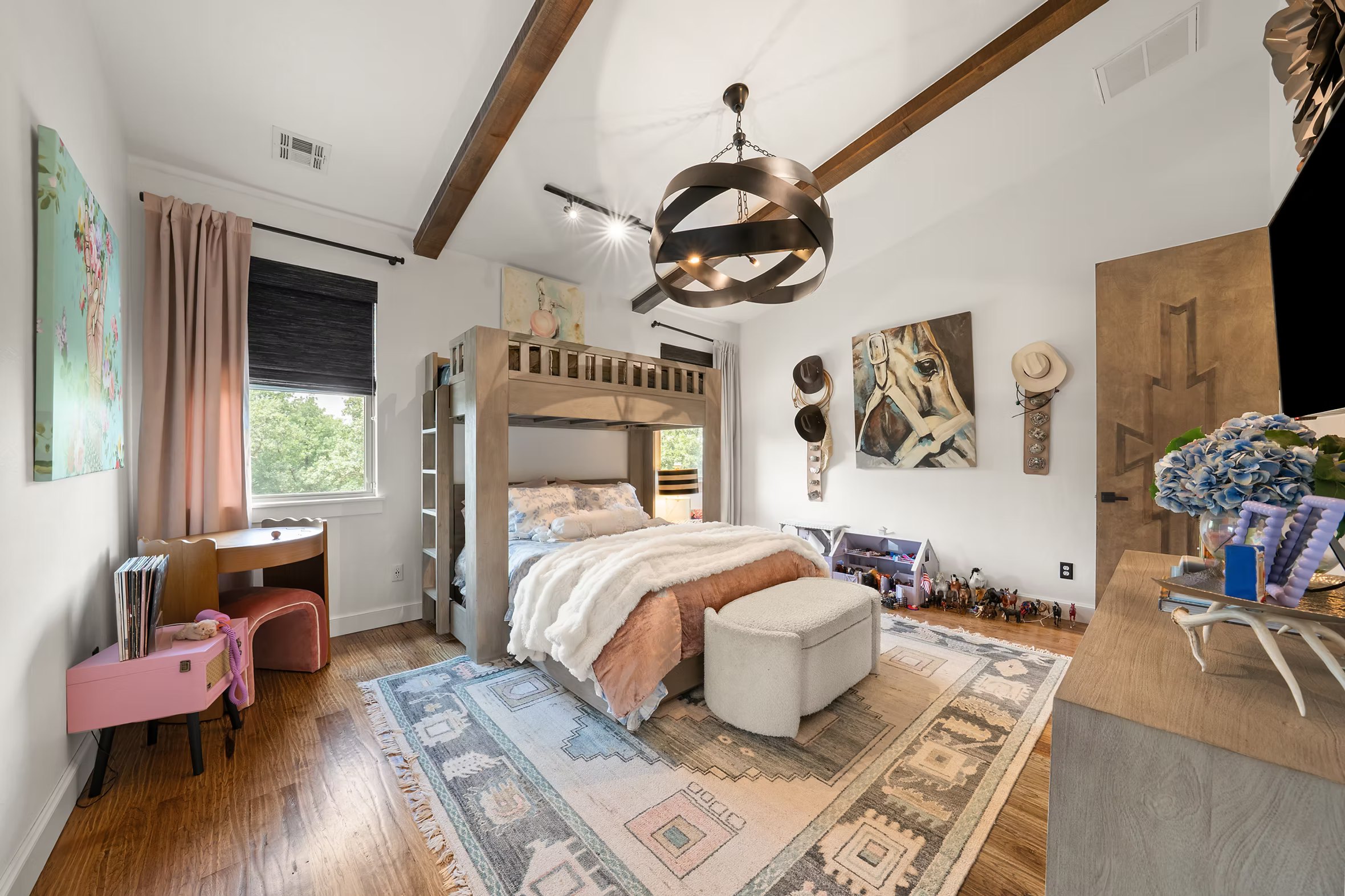 Children's bedroom with a lofted bunk, horse art, soft pink and a sculptural light