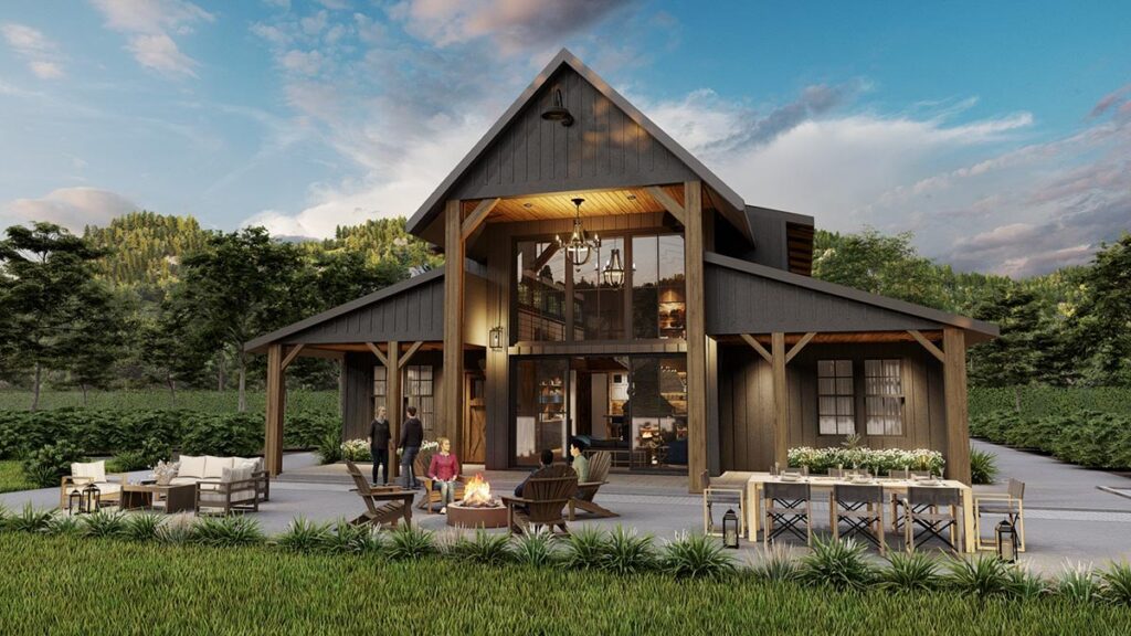 Barndominium house plan exterior at dusk with timber-framed gable, two-story glass and fire pit patio