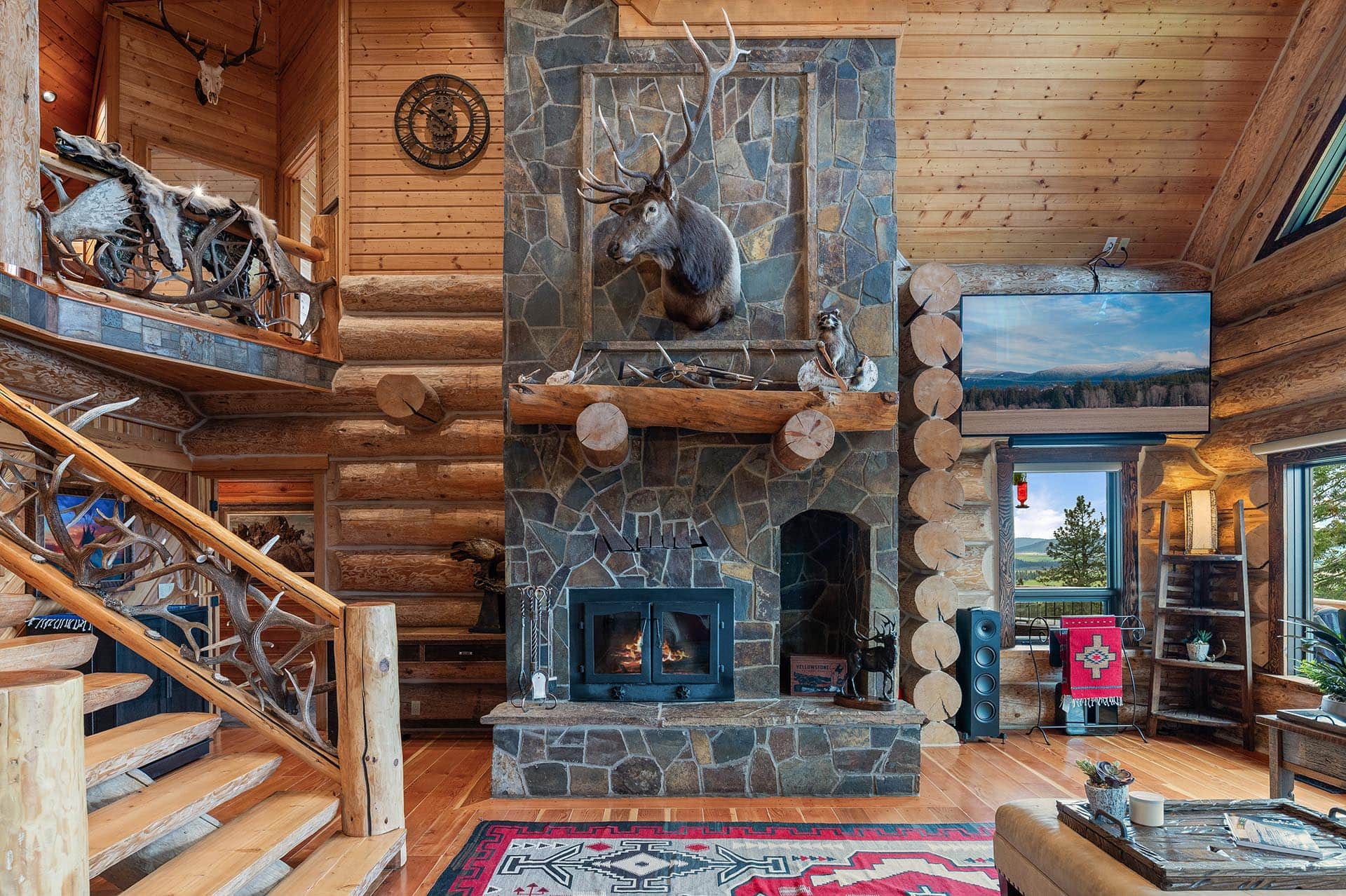 Floor-to-ceiling stone fireplace in the great room at Painted Rose Ranch