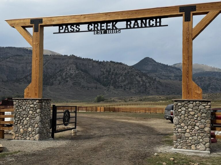 frisco gate timber frame ranch entrance river rock pillars 1 768x576