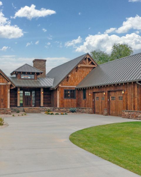 Rustic mountain ranch house plan exterior with wood siding, gable roof and covered porch, 3 bedrooms, 2,886 sq ft