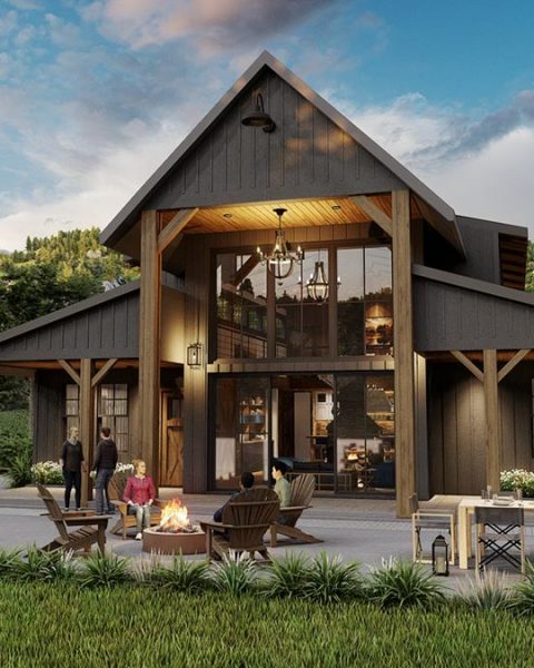 Barndominium house plan exterior at dusk with timber-framed gable, two-story glass and fire pit patio, 4 bedrooms, 3,247 sq ft